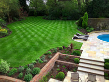 Large lush lawn with stripes treated by GreenThumb Guildford
