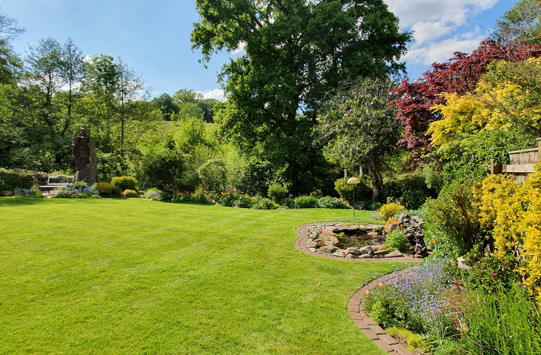 picture perfect GreenThumb lawn with borders and blue skies