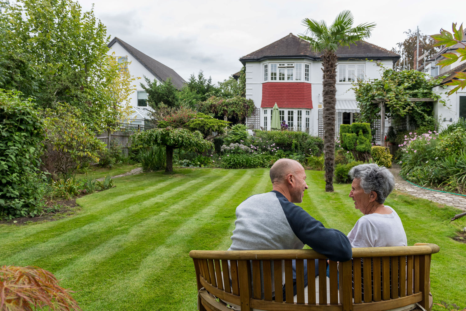Son and Mother sat enjoying their vibrant, green healthy GreenThumb Lawn