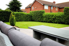 lush lawn with garden furniture treated by GreenThumb Gwynedd