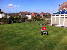 Green lawn with spreader on by GreenThumb Hastings