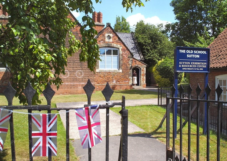 iron gates with bunting leading to Sutton Exhibition and Resources Centre