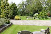 green lawn with benches treated by GreenThumb Denbighshire