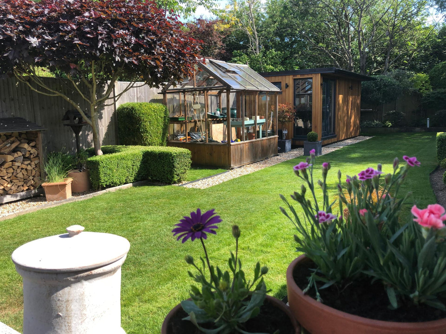 small greenthumb lawn with greenhouse and garden office/shed