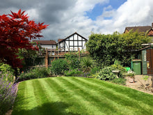 Small lush lawn with stripes treated by GreenThumb Guildford
